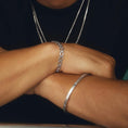 Load image into Gallery viewer, Brushed Silver Bangle Bracelet with Baguette Sapphire Accent
