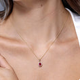 Oval Lab-Created Ruby with Floral Moissanite Halo Pendant Necklace